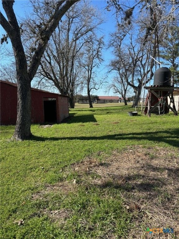 view of yard with an outbuilding and a playground