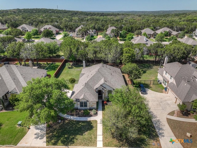 bird's eye view featuring a residential view and a forest view