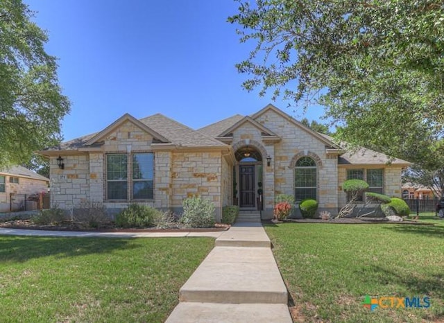 view of front of property with stone siding and a front lawn