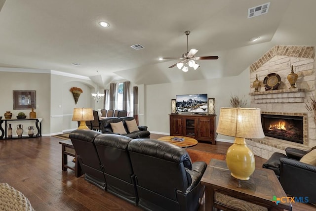 living room featuring dark wood-style flooring, visible vents, baseboards, and a ceiling fan