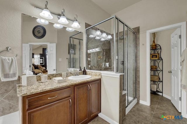 full bathroom with tile patterned floors, a shower stall, connected bathroom, and vanity
