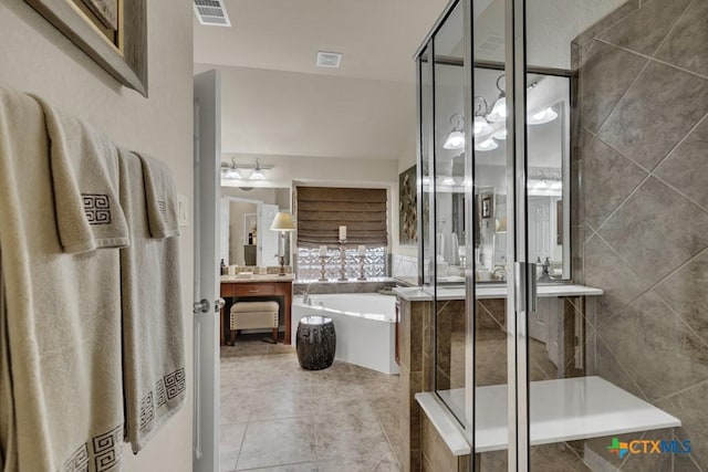 bathroom with visible vents, a tub to relax in, a shower stall, vanity, and tile patterned flooring