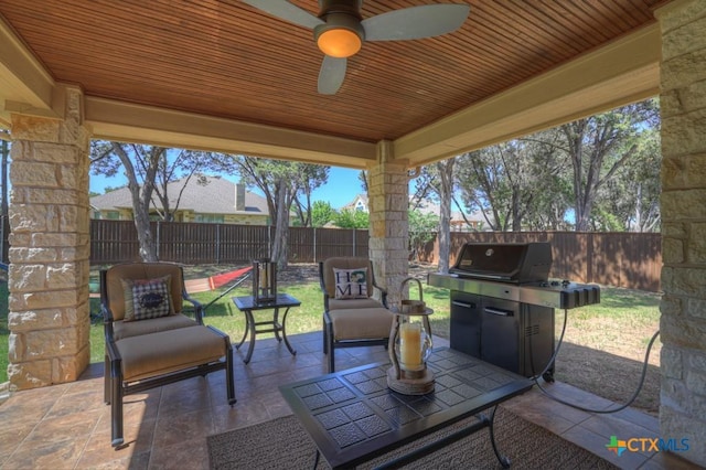 view of patio / terrace with a fenced backyard and a ceiling fan