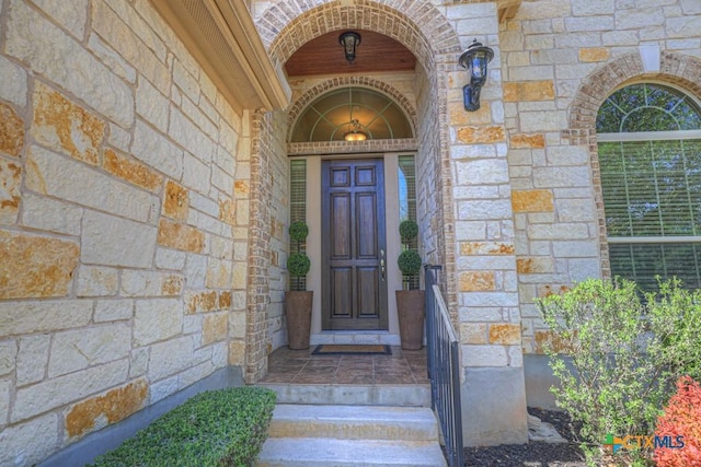 view of exterior entry with stone siding