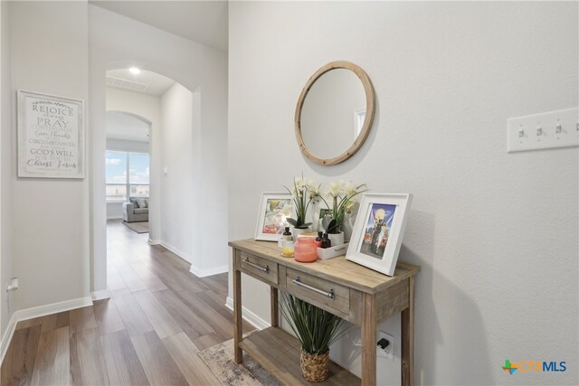 hallway with light hardwood / wood-style flooring