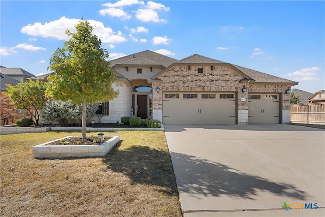 view of front of property with a garage and a front lawn