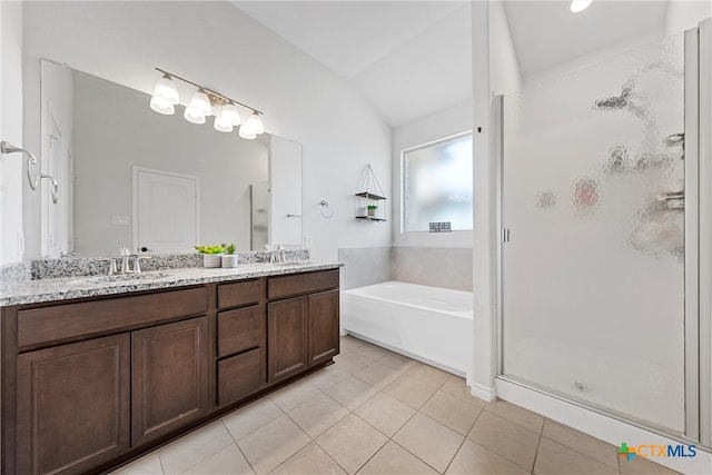 bathroom featuring tile patterned flooring, vanity, vaulted ceiling, and separate shower and tub