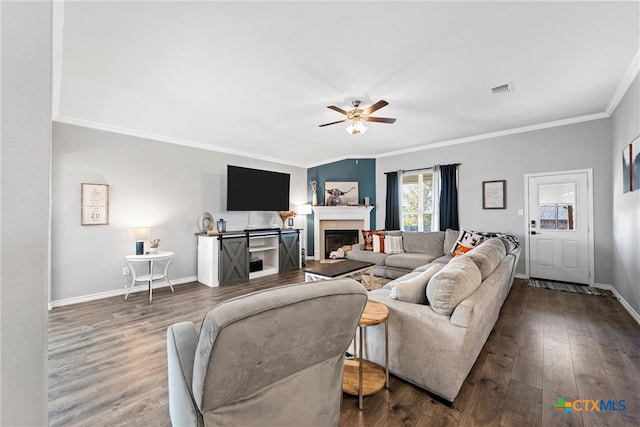 living room featuring hardwood / wood-style floors, ceiling fan, and crown molding