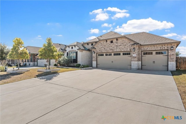 5502 Kent Dr, Belton, TX 76513 - french country style house with driveway, a garage, brick siding, stone siding, and a shingled roof