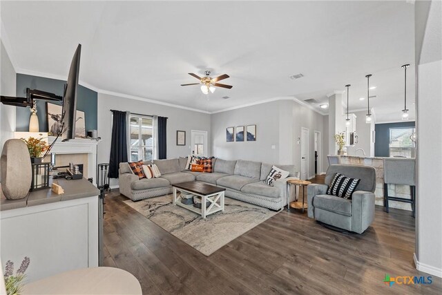 5502 Kent Dr, Belton, TX 76513 - living area with ornamental molding, ceiling fan, and dark wood-style flooring