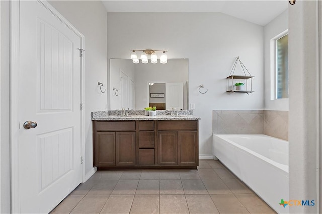 5502 Kent Dr, Belton, TX 76513 - bathroom with double vanity, a garden tub, tile patterned floors, and vaulted ceiling