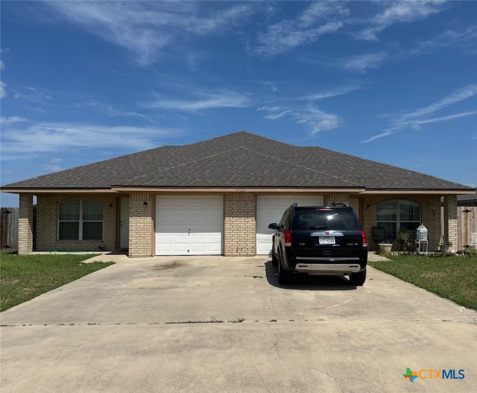 4102 Jeff Scott Dr, Killeen, TX 76549 - ranch-style home with concrete driveway, an attached garage, brick siding, and roof with shingles
