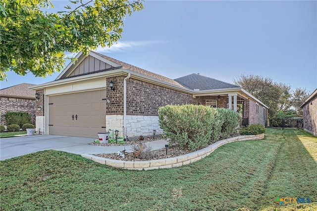 view of side of home with a garage and a lawn