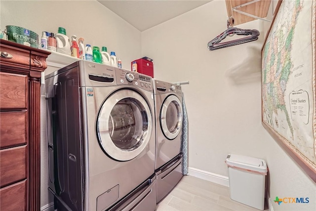 washroom with washing machine and clothes dryer