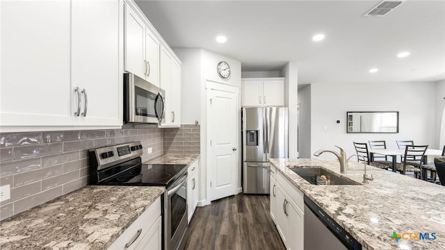 3608 Space Cloud Dr, New Braunfels, TX 78130 - kitchen featuring stainless steel appliances, a sink, dark wood-type flooring, white cabinetry, and light stone counters
