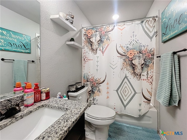 full bathroom featuring toilet, shower / tub combo with curtain, and vanity