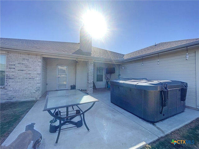 view of patio / terrace with a hot tub