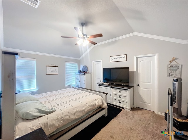 bedroom with ceiling fan, crown molding, lofted ceiling, and light colored carpet