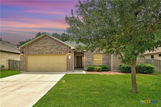 834 Oyster Crk, Buda, TX 78610 - view of front of property featuring an attached garage, concrete driveway, and brick siding