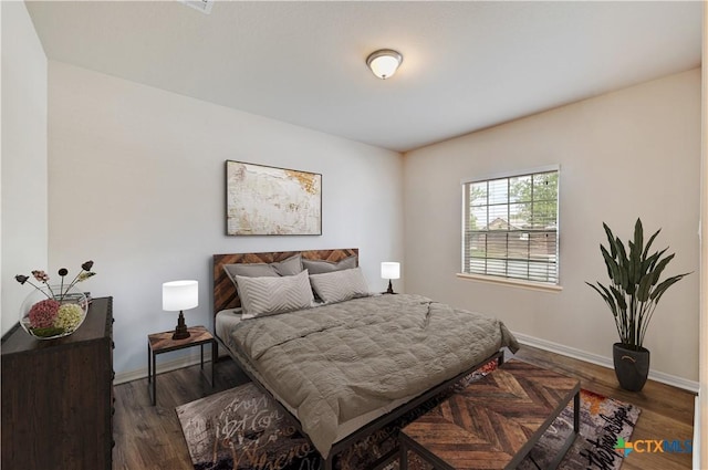 834 Oyster Crk, Buda, TX 78610 - bedroom featuring baseboards and wood finished floors