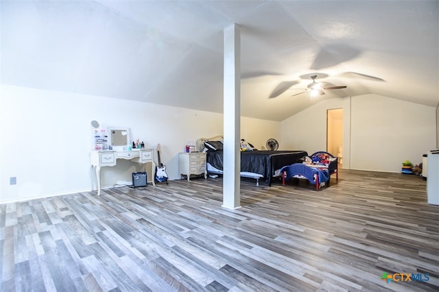 bedroom featuring hardwood / wood-style floors, vaulted ceiling, and ceiling fan