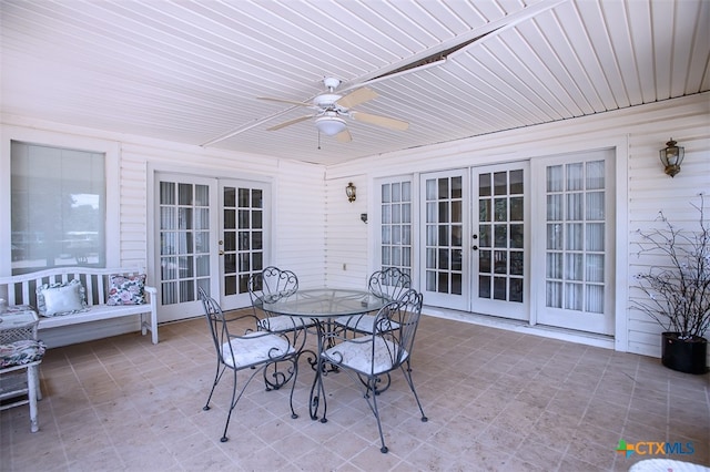 sunroom with ceiling fan, french doors, and wooden ceiling