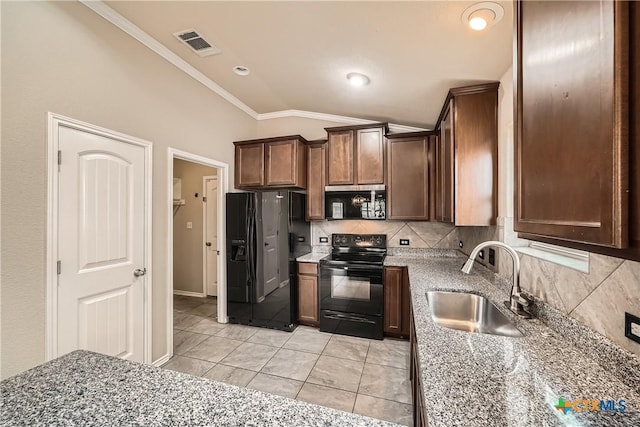 19308 Nicole Ln, Pflugerville, TX 78660 - kitchen with black appliances, a sink, vaulted ceiling, decorative backsplash, and crown molding