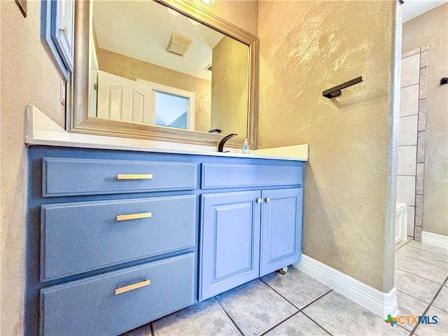 bathroom with vanity and tile patterned flooring