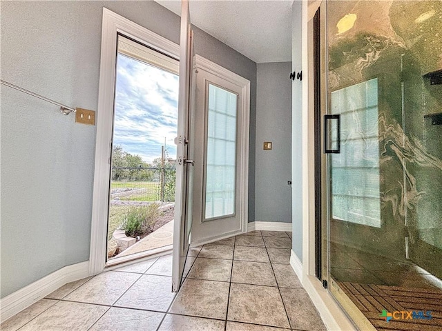 doorway with light tile patterned flooring