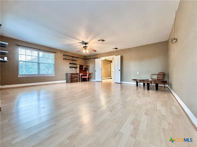 unfurnished living room with ceiling fan and light wood-type flooring