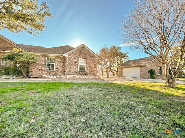 single story home with a garage and a front yard