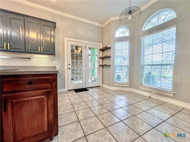 doorway to outside with light tile patterned flooring, ornamental molding, and a notable chandelier