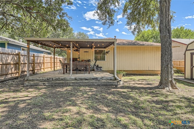 back of house with a shed, ceiling fan, and a patio