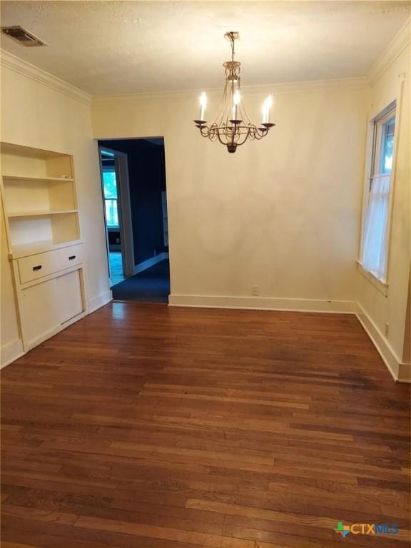 unfurnished dining area featuring crown molding, dark wood-type flooring, visible vents, baseboards, and a notable chandelier