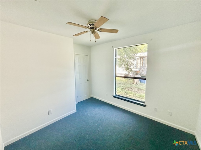 carpeted empty room featuring plenty of natural light and ceiling fan