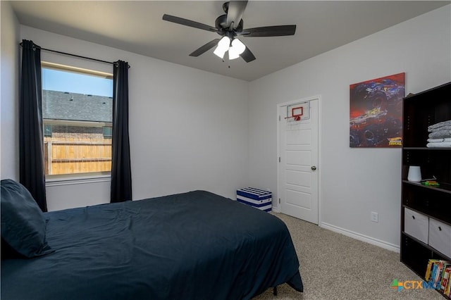 bedroom featuring baseboards, a ceiling fan, and light colored carpet