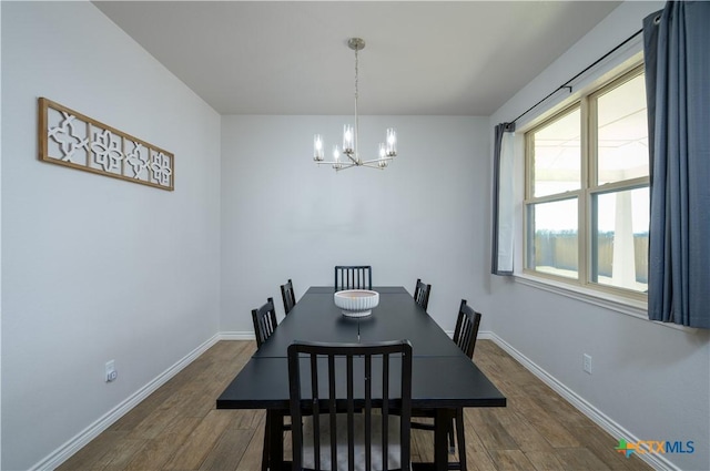 dining area featuring dark wood-style floors, baseboards, and a chandelier