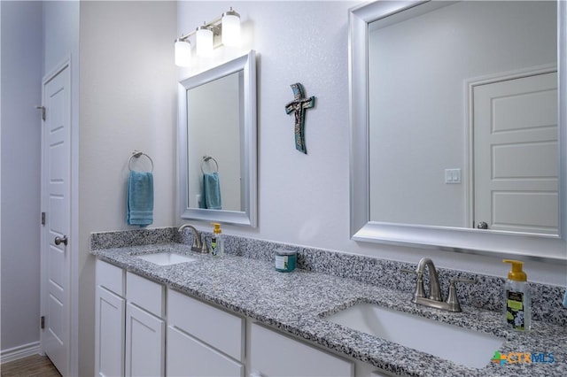 bathroom with double vanity and a sink