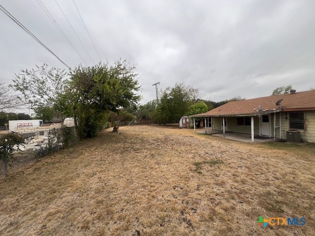 view of yard featuring central AC and a patio