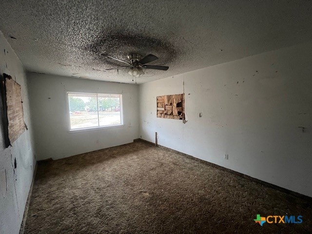 unfurnished room with ceiling fan, carpet floors, and a textured ceiling