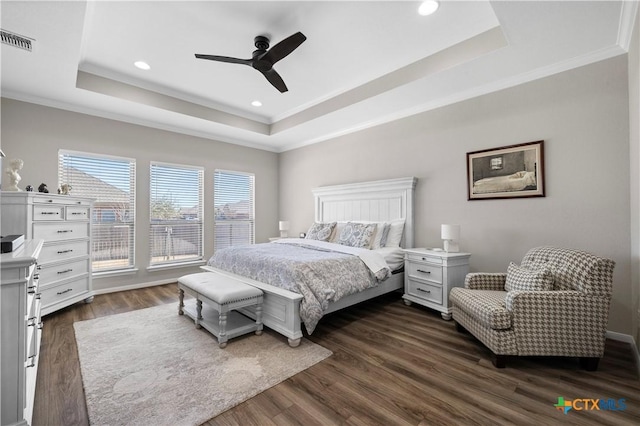 bedroom featuring visible vents, a raised ceiling, dark wood-style floors, ornamental molding, and recessed lighting