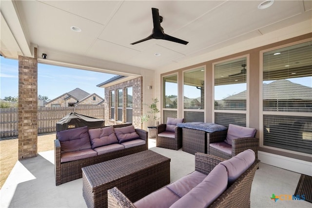 view of patio / terrace with an outdoor hangout area, fence, and a ceiling fan