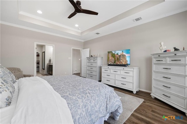 bedroom featuring recessed lighting, dark wood-type flooring, visible vents, a tray ceiling, and crown molding