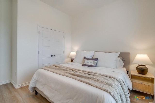 bedroom featuring hardwood / wood-style flooring and a closet