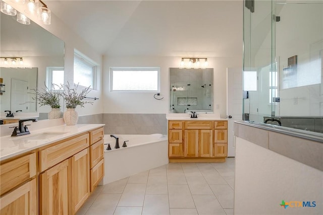 bathroom with plus walk in shower, tile patterned flooring, vanity, and vaulted ceiling