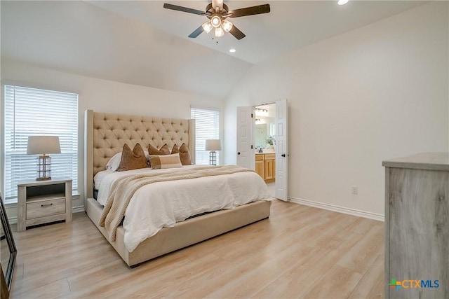 bedroom featuring ceiling fan, lofted ceiling, ensuite bathroom, and light hardwood / wood-style flooring