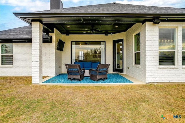 back of house with a lawn, outdoor lounge area, ceiling fan, and a patio