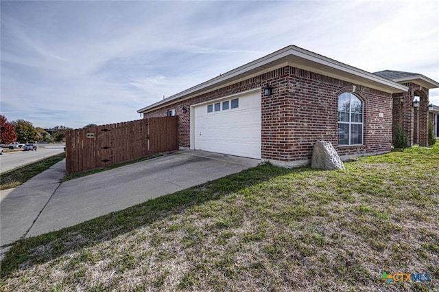 view of side of home with a yard and a garage