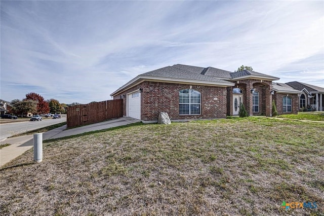 view of front facade with a front yard and a garage