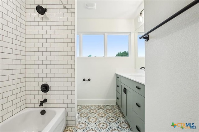 bathroom featuring vanity and tiled shower / bath